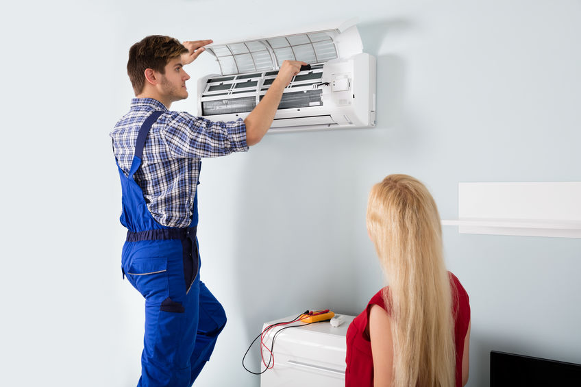 Technician Repairing Air Conditioner At Home
